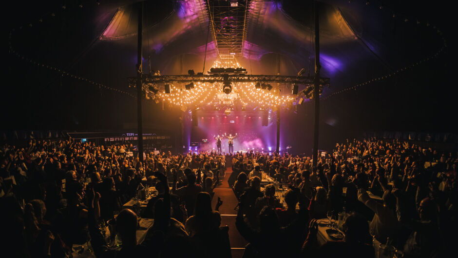 View inside TIPI AM KANZLERAMT showing stage, lighting, and audience at an event.